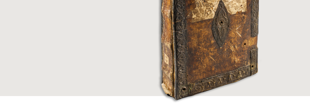 Header graphic showing a manuscript in brown binding, standing upright.